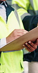 Hands, writing and engineer in city with clipboard, inspection and quality control for construction. Person, survey and checklist outdoor for architecture, urban evaluation and information on project