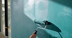 Person, hand and paint for renovation in home, upgrade and interior design with improvement. Paintbrush, equipment and remodeling with DIY project, maintenance and color for wall and process