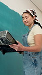 Woman, excited and painting wall with brush for creativity, self expression and therapeutic hobby. Process, Korean person and home decor with diy project, interior design and paint for renovation