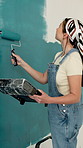 Woman, renovation and painting wall with brush for creativity, self expression and therapeutic hobby. Process, personalisation and home decor with diy project, interior design and balance on ladder