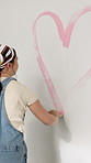 Paint, heart and woman with paintbrush for home improvement, interior design and remodeling project. Color, transformation and person with tool for house renovation, back and creative wall decor