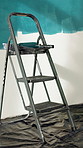 Creative, ladder and painting on wall with equipment, DIY project and renovation. Empty, decoration and tools with maintenance, apartment and process in home, watercolor and design with remodeling