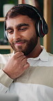 Headphones, laptop and thinking with man on sofa in home for planning, remote work or research. Computer, decision and streaming with happy person in apartment for feedback or report as freelancer