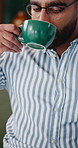 Man, freelancer and coffee with laptop in home for morning business, network or online connection. Male person, user or drinking caffeine with computer on sofa for remote work, research or news