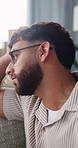 Mental health, thinking or man on sofa with regret, anxiety trigger or memory of past trauma. Flashback, reflection or person in home with depression, overthinking or emotional fatigue in living room