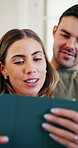 Couple, smile and bonding with tablet in lounge, streaming or relax with partner on weekend in house. Happy people, online and watching movies with app subscription, laughing and funny video in home