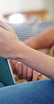 Couple, hands and sofa with tablet in home for online entertainment, subscription or app together. Man, woman or browsing with technology or network on couch for browsing, movie or series in house