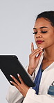 Thinking, doctor and woman with tablet in studio, decision and plan for health solution and wellness. White background, medical professional or person with tech, problem solving and healthcare on web