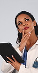 Doctor, decision and woman with tablet in studio, thinking and plan for health solution and wellness. White background, medical professional or person with tech, problem solving and healthcare on web