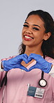 Health, doctor and face with heart hands in studio for medical support, pediatric care or trust. Pediatrician, woman and laugh with love emoji on white background for assurance, integrity or kindness
