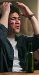 Disappointed, man and watching tv in sports bar with England flag, beer or football competition loss. Frustrated, person and soccer broadcast in pub with alcohol drink, suspense or game defeat stress