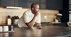 Break, morning and thinking with black man in kitchen of home for ideas, inspiration or vision. Daydreaming, mindfulness and relax with person at counter in apartment for planning or reflection