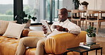 Black man, coffee and remote work in home with tablet, research and proofreading for copywriting. Journalist, beverage or freelancer in living room with digital, editing article and story publication
