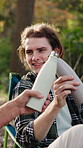 Men, happy and toast with drink for camping, bonding and relax in nature environment to celebrate. Friends, bottle and cheers with beverage on holiday, vacation or trip in woods outdoor for wellness