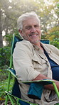 Face, holiday and senior man on camping chair for relax, travel and happiness on outdoor break. Campsite, vacation and elderly person in nature with peace in retirement, calm and smile in Finland