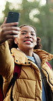 Hiking, vlog and happy woman with phone for tutorial in forest for outdoor journey or adventure. Active, female person or vlogger showing path for online streaming, guide or trekking tips in nature