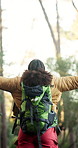 Backpack, hiking and woman in forest for freedom, holiday adventure and explore for wanderlust goal. Back, trekking and person in nature with open arms, walking or travel with journey success
