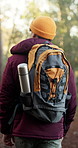 Backpack, hiking and man in forest for exploration outdoor, holiday adventure and sightseeing trip. Back, trekking and person in nature for eco tourism, walking and travel on journey for vacation