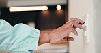 Hands, electrician and person with light switch, test and remodeling with maintenance. Closeup, man and specialist with fixture, renovation or engineering with contractor for home or system repair