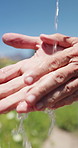 Farmer, water and washing hands in field, person and hygiene for bacteria, soil or dust in summer. Outdoor, cleaning and liquid for germs, dirt and sand with sustainability for agriculture in Canada