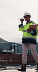 Construction, rooftop and woman with radio and clipboard for update, communication and inspection. Walking, architecture and person with feedback for quality control, compliance report and checklist