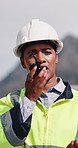 Construction, talking and woman with radio in city for update, communication and inspection. Rooftop, architecture and person with feedback for quality control, compliance report and maintenance