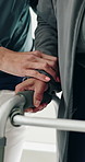 Physiotherapy, hands and help with walker at clinic for mobility, balance and support in retirement. People, caregiver and elderly patient with disability, frame or rehabilitation for healing