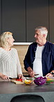 Laugh, cooking and old couple with chopping board for vegetables, healthy diet or wellness in kitchen. Slice ingredients, senior man and woman with help at home, vegetarian nutrition or funny chat
