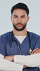 Crossed arms, serious and face of nurse in studio with confidence for career in medical service. Man, professional and portrait of healthcare worker with pride for about us on white background.