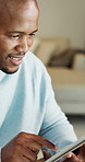 Smile, black man and typing in home with tablet, research and finance report for mortgage payment. Person, reading or house with tech for email, review budget and loan application for household bills