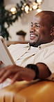 Laughing, man and thinking with tablet in lounge, online or watching movie with subscription in home. Happy, black person and streaming funny video on website, reflection and entertainment in house