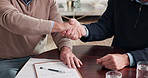 Documents, handshake and business men in home for finance deal, negotiation or contract for investment. Paperwork, partnership and male financial advisor shaking hands with customer in house.