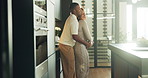 Happy, hug and couple in kitchen at house with bonding, support or connection in marriage. Smile, commitment and black man embracing woman for safety, love and care in relationship at apartment.