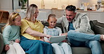 Tablet, children and parents bonding in family home, streaming movie and show selection. Technology, mother and father with sisters in living room to relax, talking and pointing for film choice