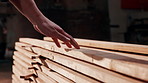 Carpentry, wood and hands of man in workshop for manufacturing, furniture repair and inspection. Factory, carpenter and person with planks, material and timber for woodworking and lumber production