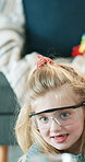 Family, science and child with glasses in house, development and bonding with parent in living room. Eyewear, choice and woman with smile for experiment, growth and medical research with girl in home