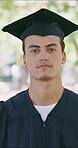Graduation, face or man outdoor with pride, university milestone or ambition in academic achievement. Education, bokeh or college student with portrait, confidence or success in farewell ceremony.