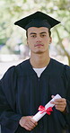 Graduation, face or man outdoor with diploma, university pride or ambition in academic achievement. Education, gown or college student with portrait, confidence or milestone in certificate ceremony.