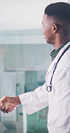 Doctor, team and handshake in hospital with discussion, collaboration and update on healthcare job. Medical worker, people and shaking hands in clinic with conversation, partnership or career advice.