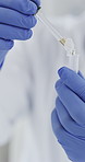 Hands, scientist and dropper with test tube at laboratory, medical research and ppe gloves for virus sample. Person, tools and equipment with pharmaceutical innovation, liquid or vaccine development