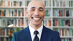 Happy, face and businessman with pride in library, knowledge and corporate lawyer with career growth. Laughing, attorney and person with job opportunity, legal books and research for case in law firm