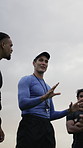Man, sport and coach with team for gameplay, meeting or discussion with rules for outdoor match. Active, male person or athletic manager talking with rugby players for competition or game on pitch