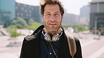 Man, face and headphones in city for travel with smile, music and bag for international tourism. Mature person, sound and happy with audio streaming, subscription and portrait for trip in urban town