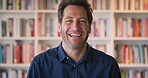 Development, face and funny with man in library as college or university professor for education. Laughing, learning and satisfaction with mature teacher in bookstore for academic job or research