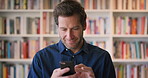 Phone, reading and scroll with man in library as college or university professor for education. App, development and learning with mature teacher in bookstore for academic job, knowledge or research