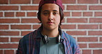 Man, face and confidence with headphones by brick wall for college education, knowledge and learning. Student, portrait and university campus for scholarship, opportunity and about us at academy