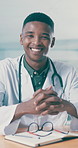 Face, healthcare and smile of doctor black man in hospital for agenda, schedule or writing. Glasses, notebook and review with happy medical professional at desk in clinic for appointment calendar