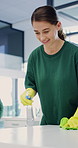 Cleaning, laughing or woman with spray bottle in office, janitorial service or hygiene maintenance. Disinfection, funny or cleaner with supplies for sanitation of workplace, happy or dirt removal
