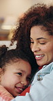 Mom, girl and hug on sofa with smile, love and bonding with connection, discussion or comfort in lounge. Happy people, mother and daughter with embrace, relationship or relax on couch at family house