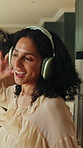 Dancing, headphones or woman in house with fun, feeling beat and listening to music playlist. Happy, sound track or person on sofa with jumping, groovy movement or playful energy with audio streaming